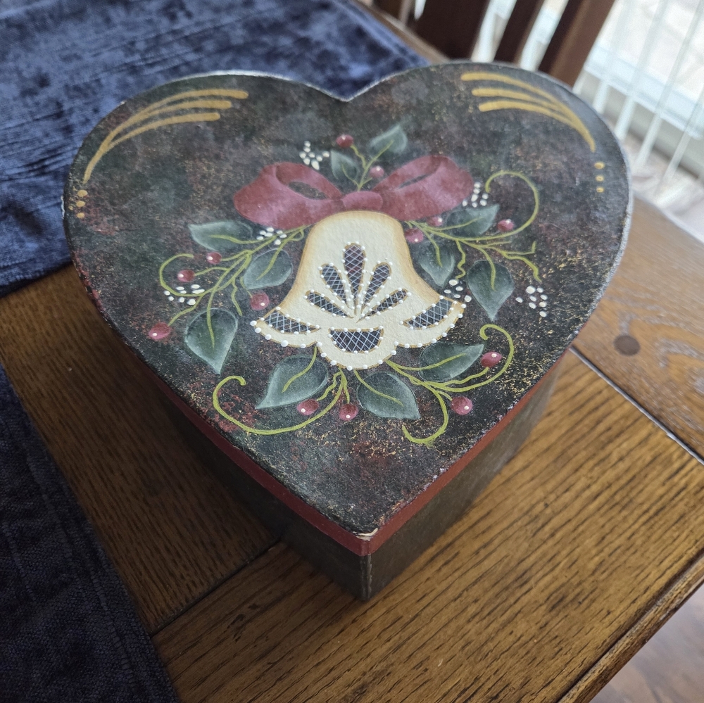 Folk Art Painted Heart Shaped Box With A Christmas Bell Painted On Top.